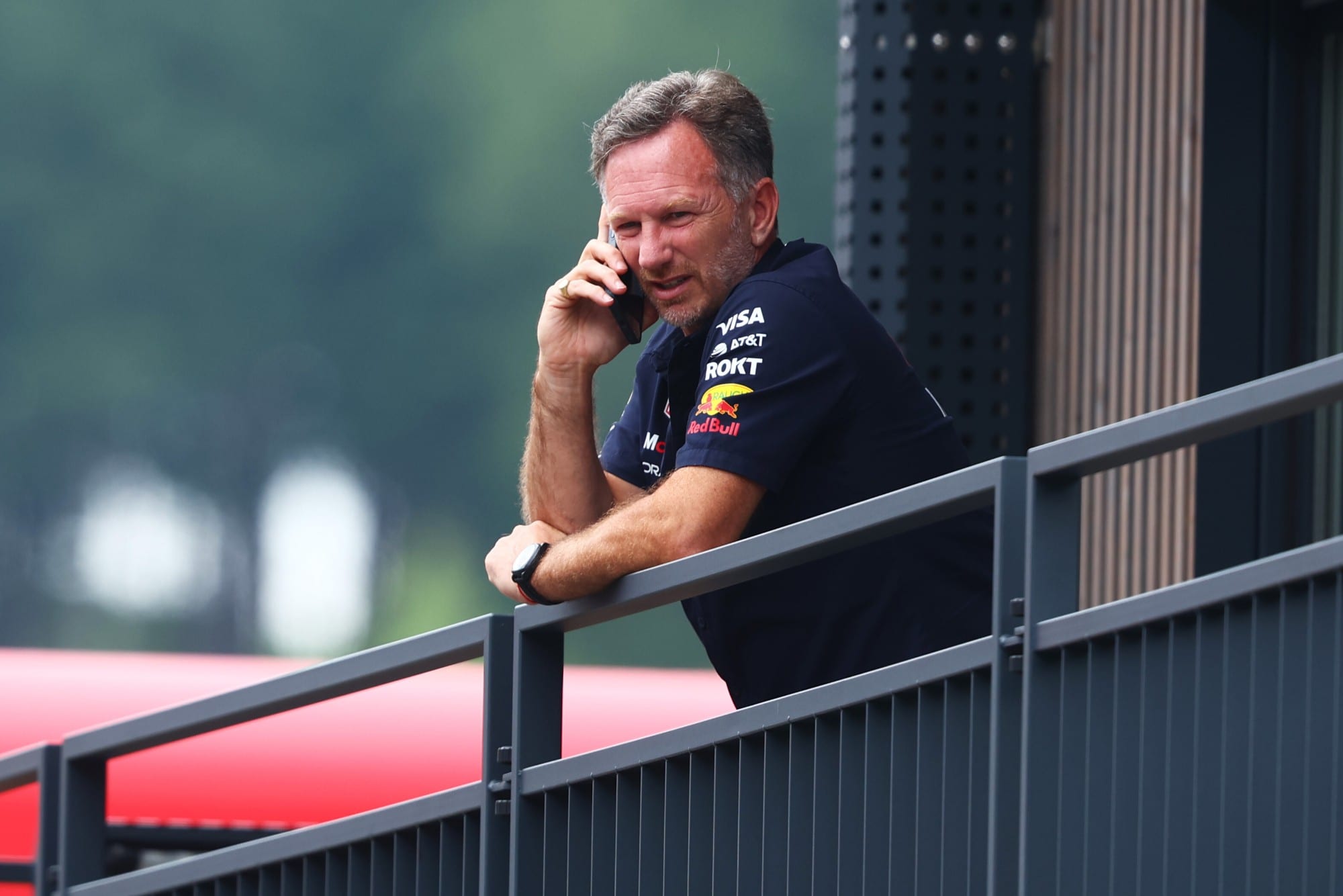 Christian Horner on the phone in the paddock at the 2025 Austrian Grand Prix