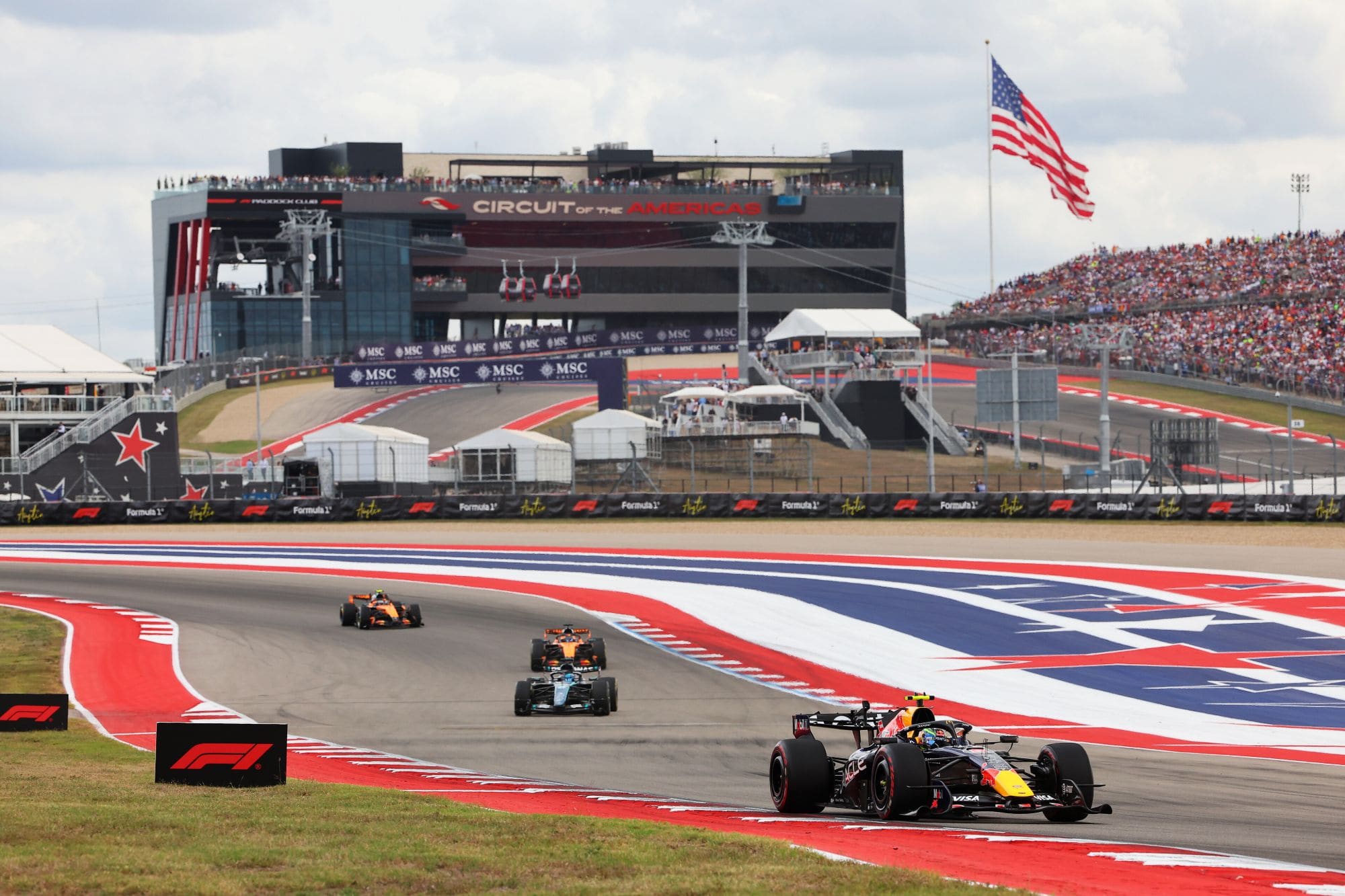 A Red Bull leads a Mercedes and both McLarens at the Circuit of the Americas