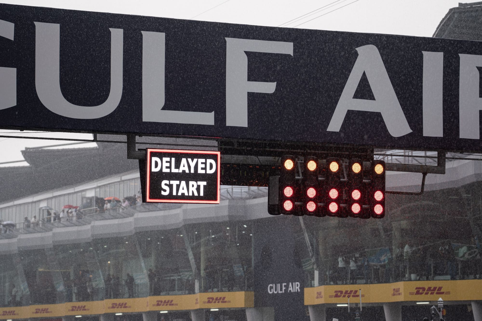 A Delayed Start board next to the start lights in heavy rain at Sepang, one week before Singapore