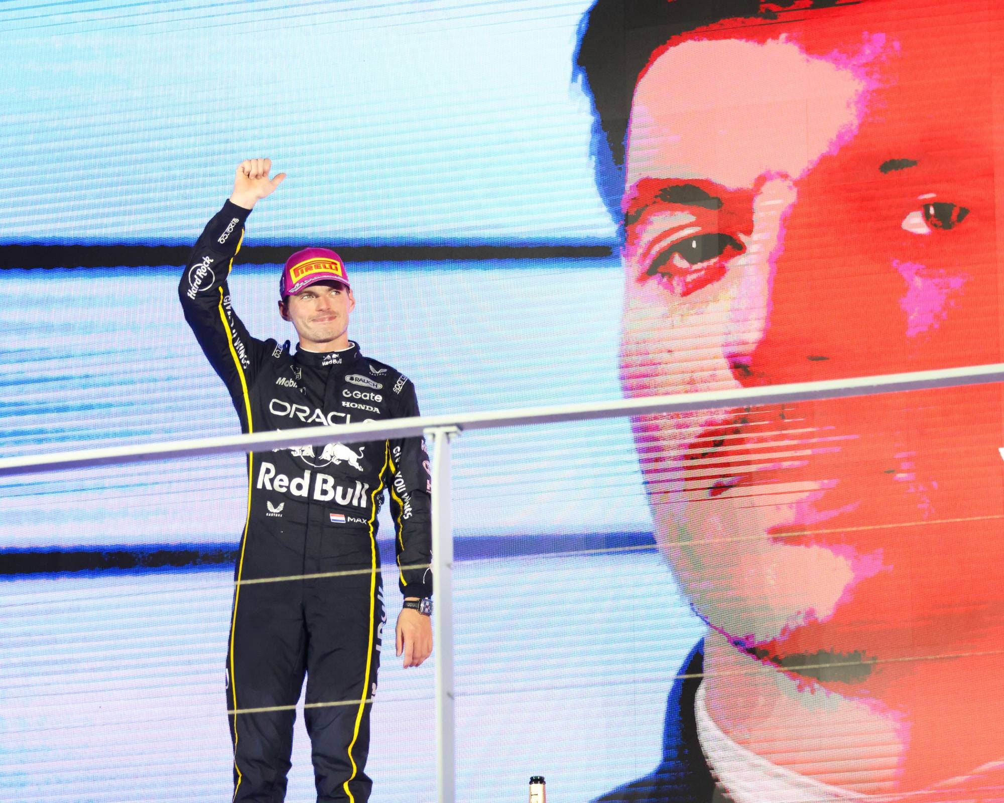 Max Verstappen waves to the crowd from the podium at the 2025 Singapore Grand Prix