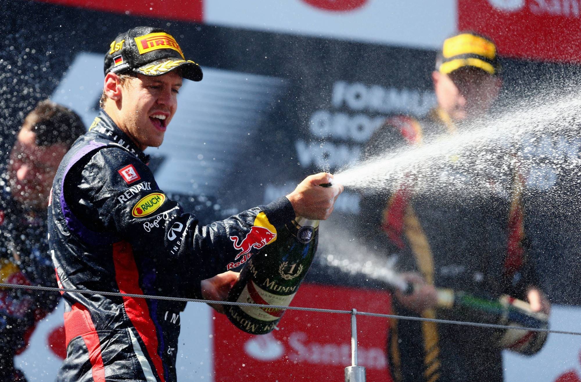 Sebastian Vettel sprays champagne on the podium after winning the 2013 German Grand Prix at the Nurburgring