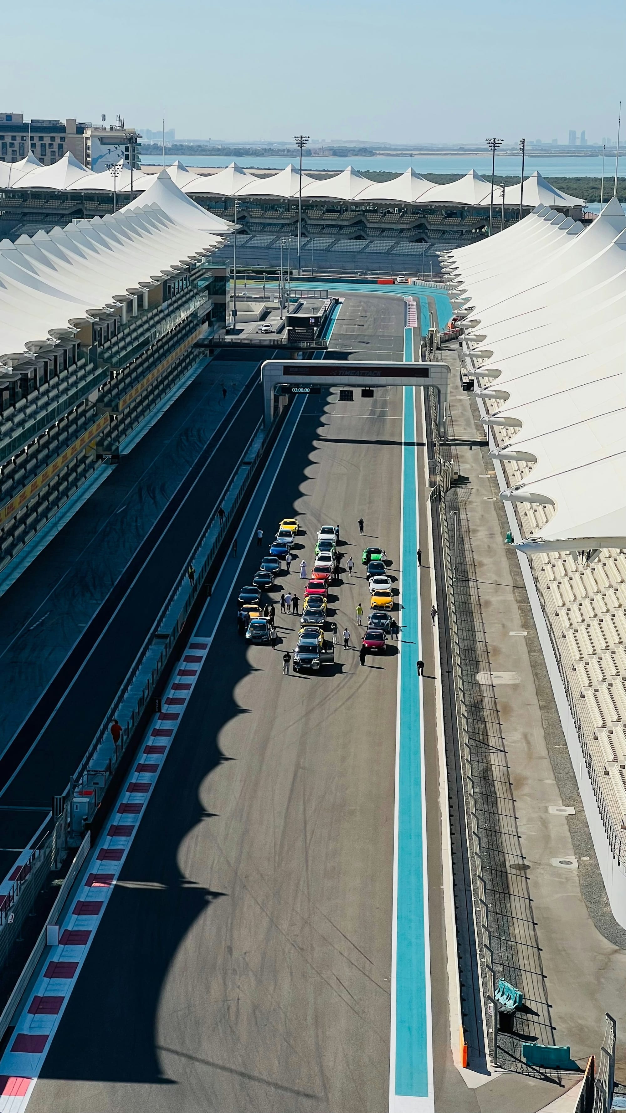 An aerial view of the main straight at Yas Marina Circuit, between the grandstand roofs