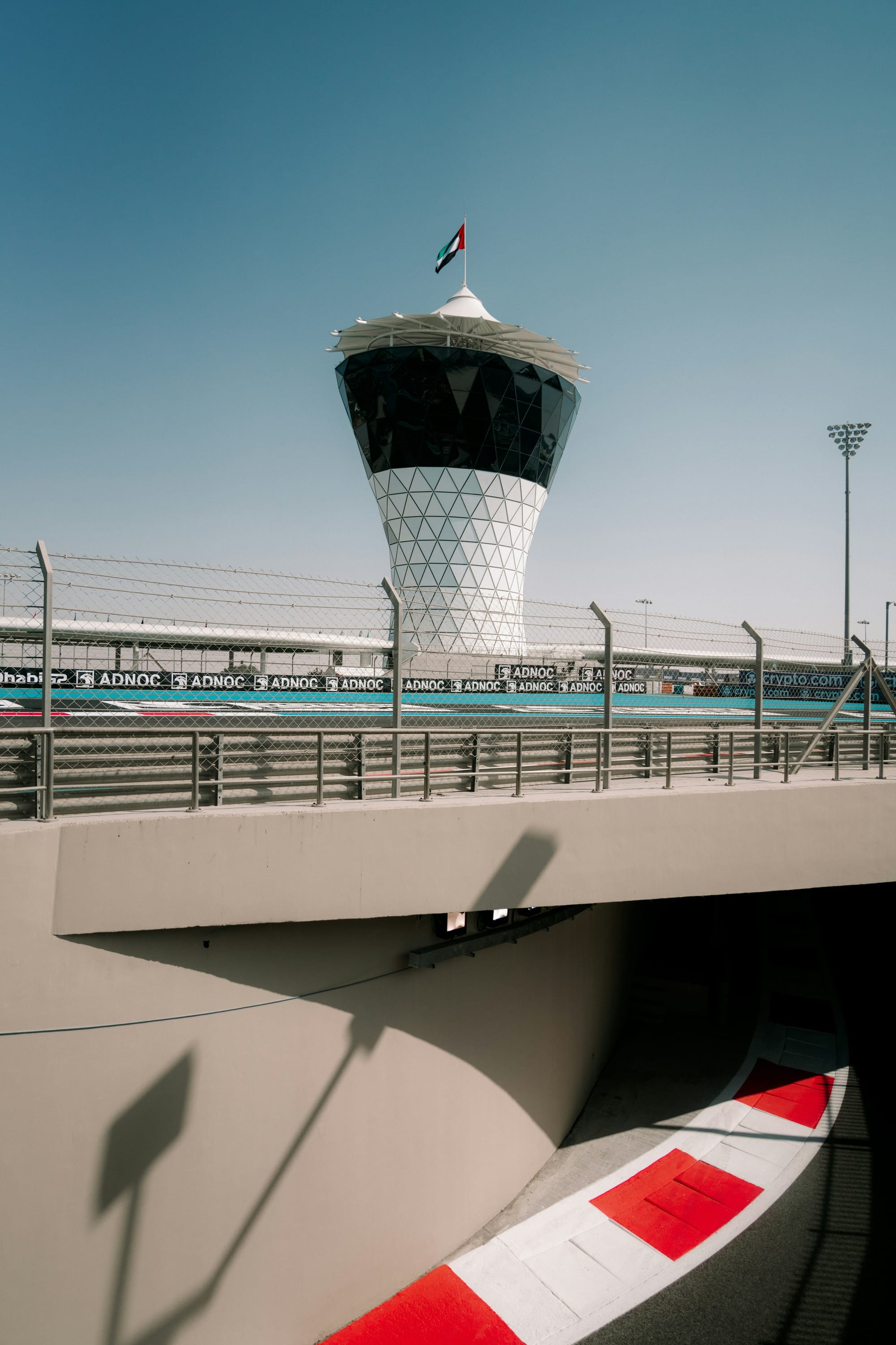 The lattice tower at Yas Marina Circuit, above a bridge over the track