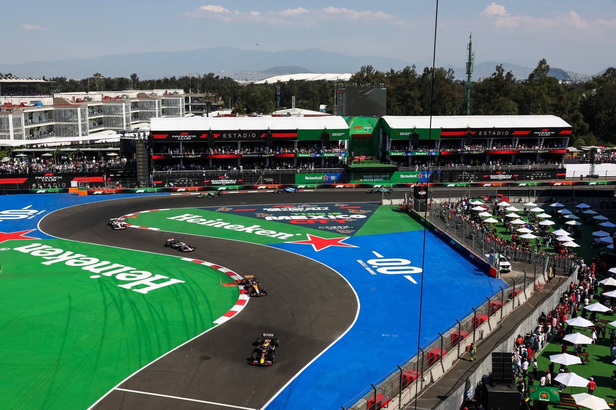 Yuki Tsunoda leads Oscar Piastri through the Foro Sol stadium section at the 2025 Mexico City Grand Prix