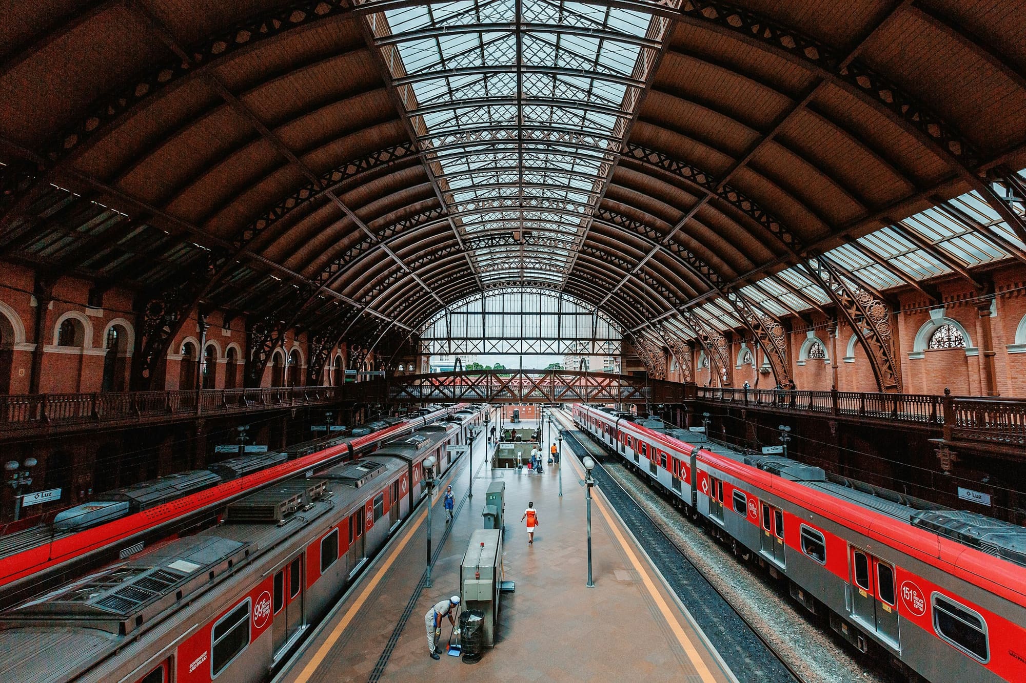 Red CPTM trains at a station platform in São Paulo